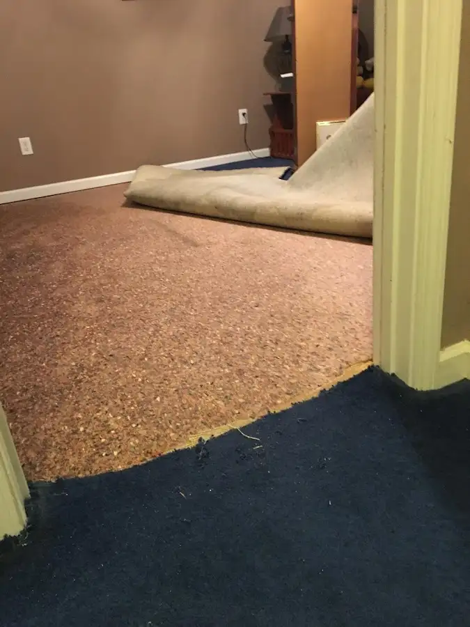 Carpet pad removal revealing water damage during Water Mitigation Services in Marrero