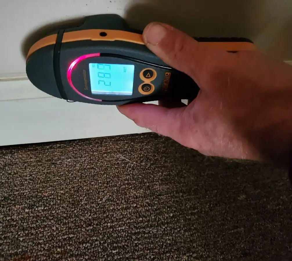 Moisture detection at baseboard during Storm Damage Restoration in Marrero